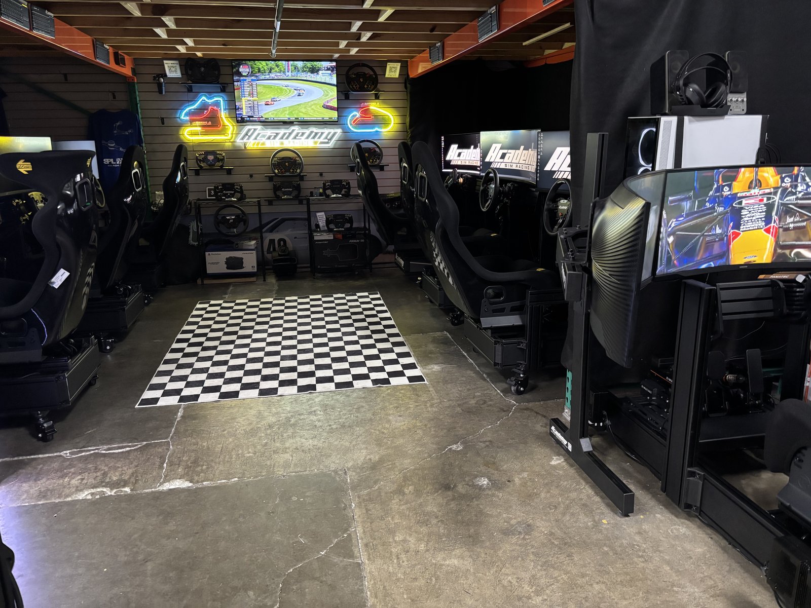 Academy Sim Racing Tampa lounge with multiple racing simulators